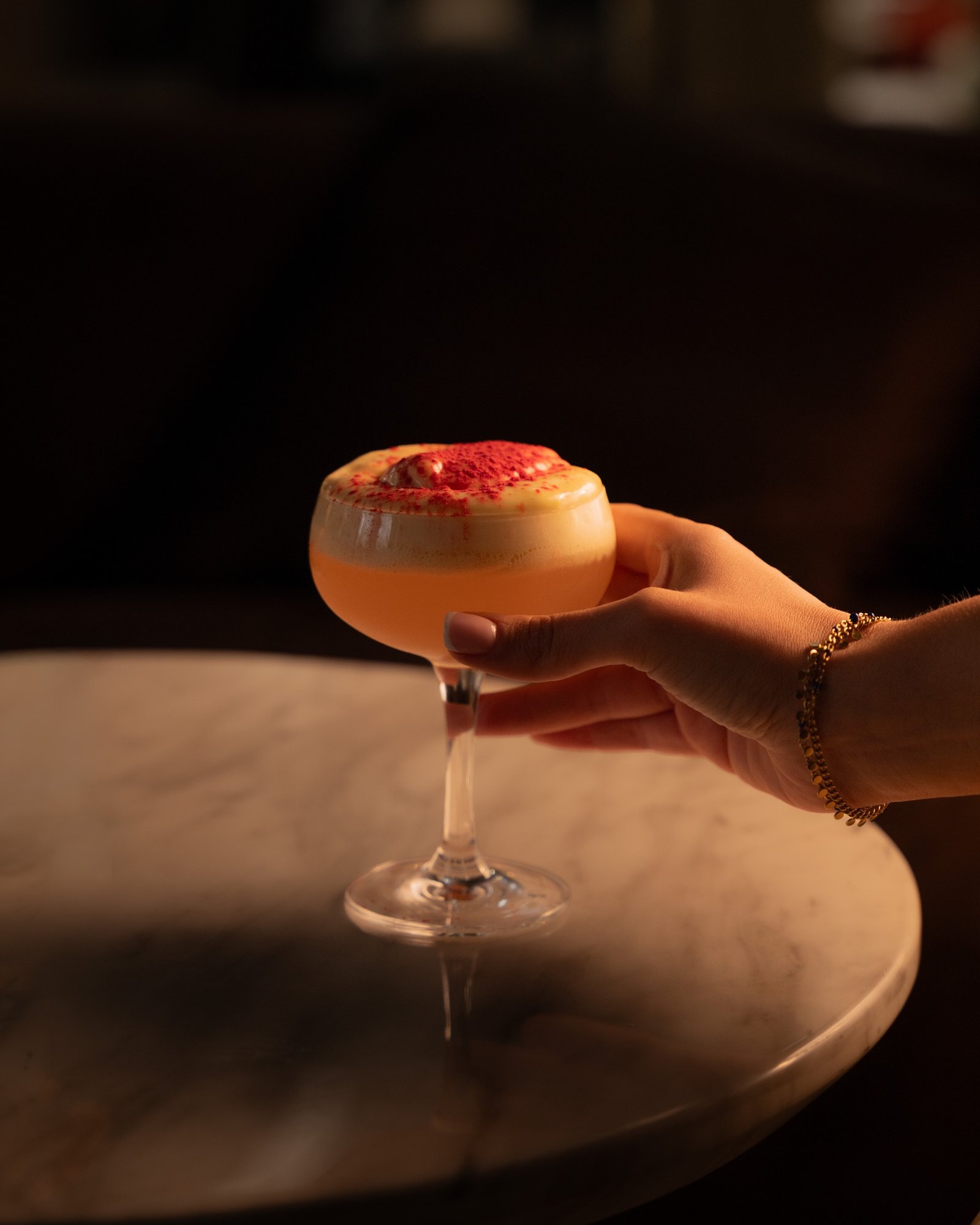 A Peach Melba cocktail held in the lounge at Moods Leeds