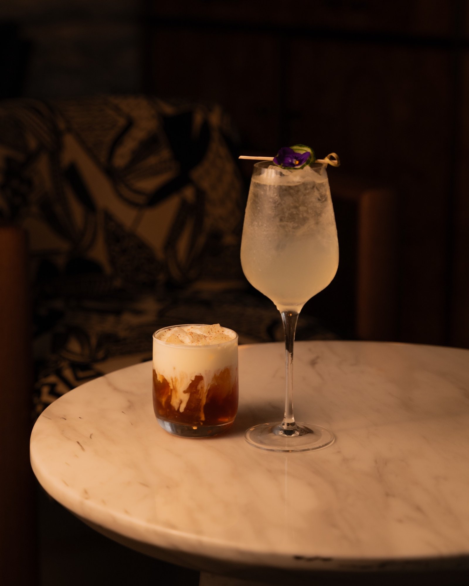 Two house cocktails on a marble table at Moods Leeds