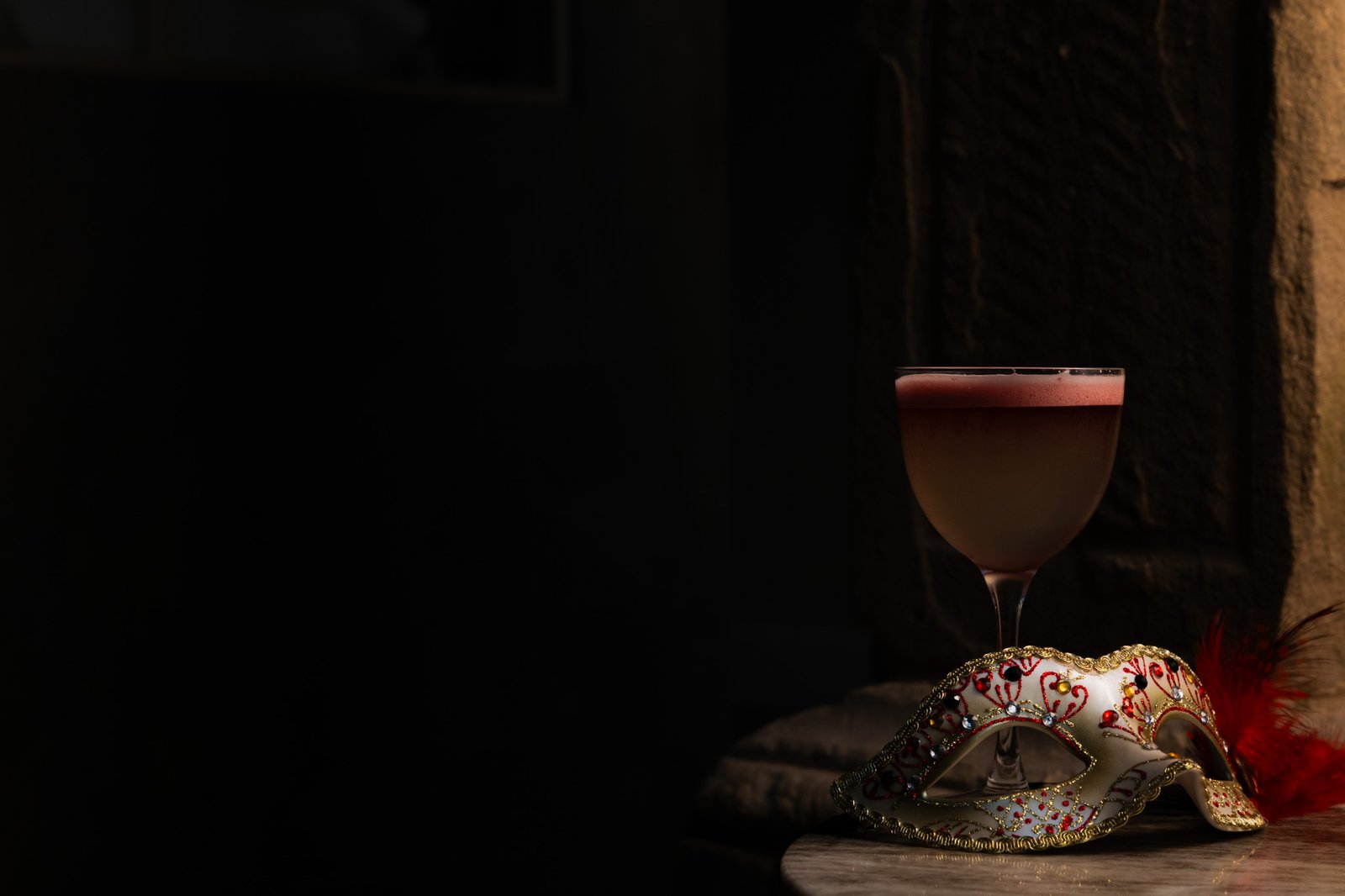 A masquerade mask and cocktail for Halloween at Moods